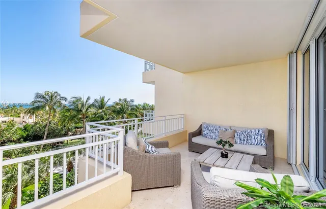 a balcony with furniture and a potted plant