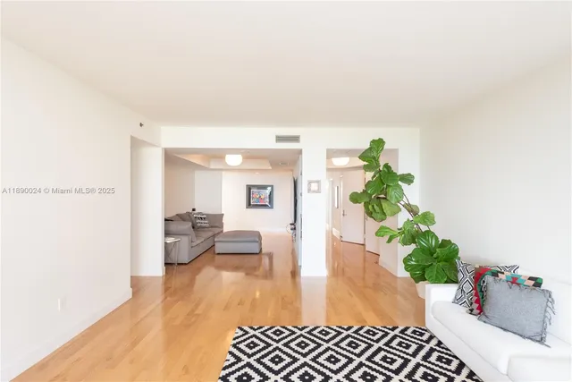 a living room with furniture and a book shelf
