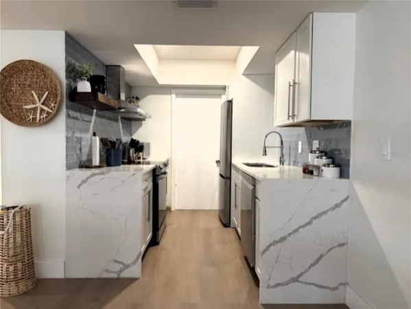 a kitchen with stainless steel appliances granite countertop a stove and a sink