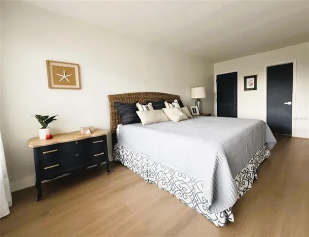 a spacious bedroom with a bed and a large window