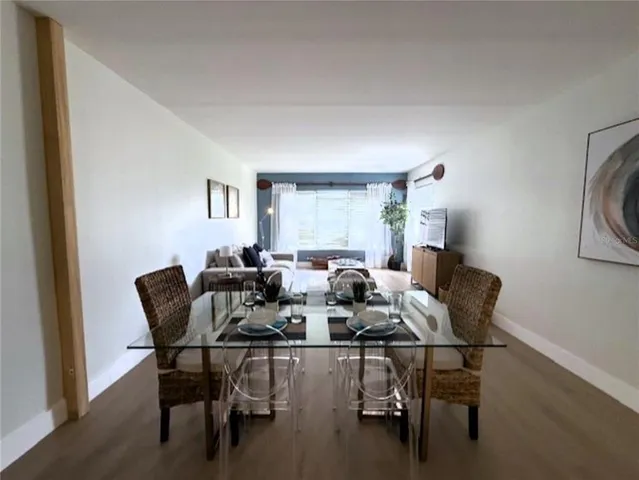 a view of a dining room with furniture and a window
