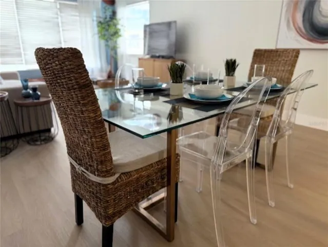 a dining room with furniture and a chandelier