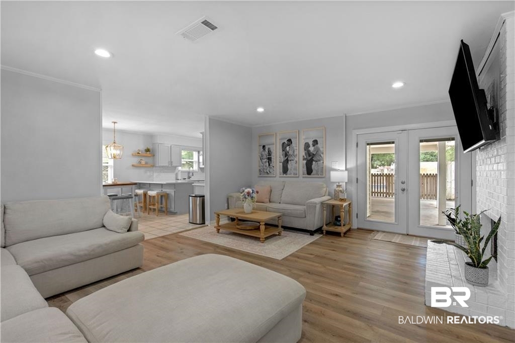 1624 Apex Drive Mobile, AL 36693 - Photo 10 of 29 Living room featuring ornamental molding, light hardwood / wood-style flooring, and french doors