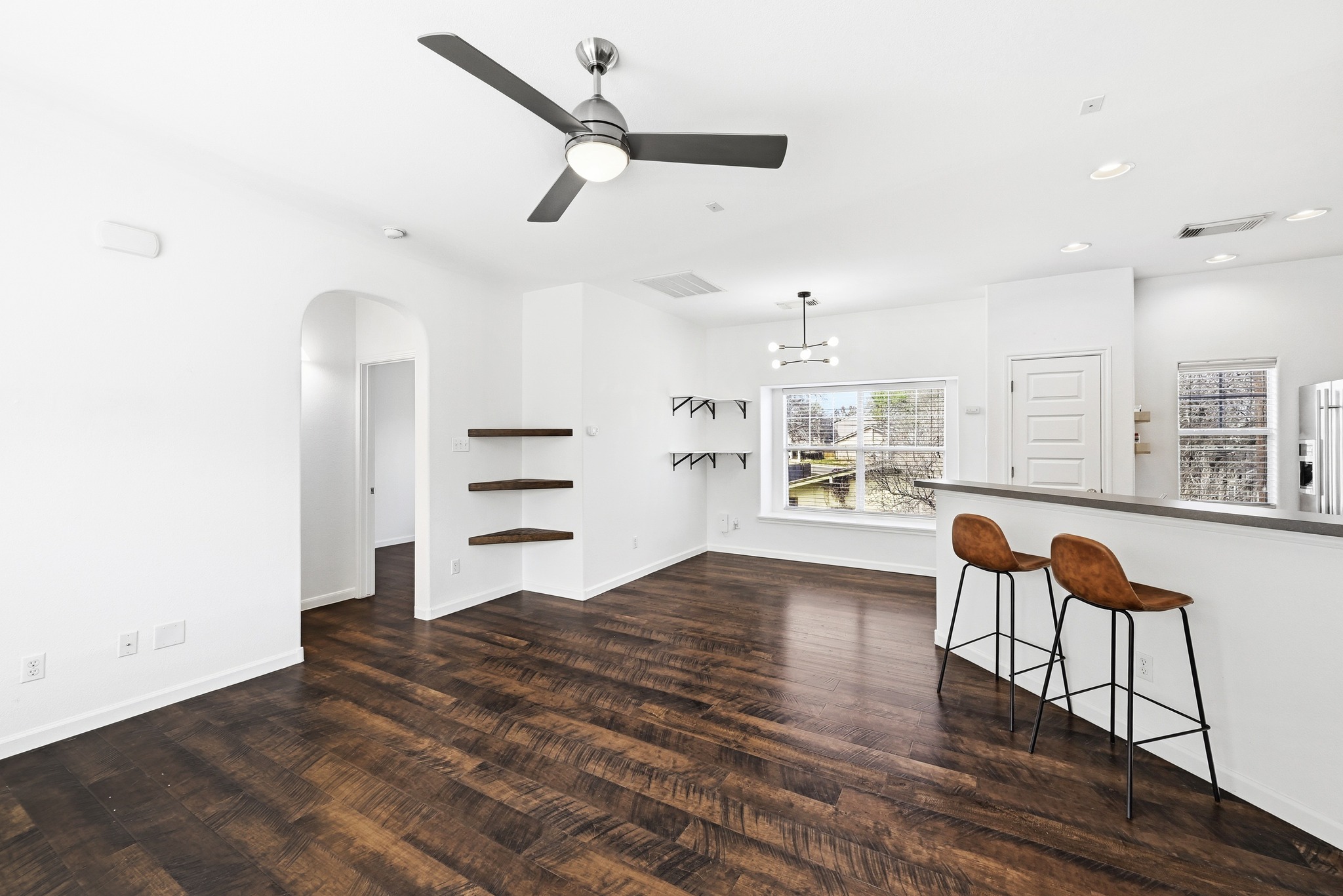 2821 Saville Loop, Unit 21C Austin, TX 78741 - Photo 31 of 31 Updated light fixtures define the transition between the living and dining spaces, keeping the open floor plan feeling organized and intentional