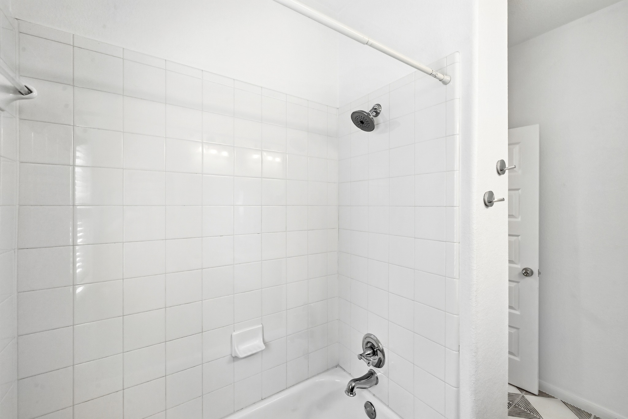 2821 Saville Loop, Unit 21C Austin, TX 78741 - Photo 24 of 31 A classic shower and tub combination offers a practical layout that makes the most of the bathroom’s footprint