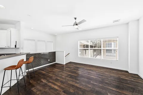 a view of workspace with wooden floor and windows