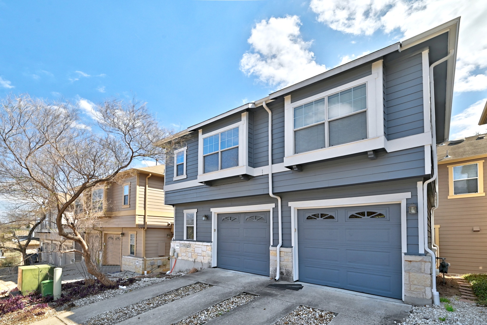 2821 Saville Loop, Unit 21C Austin, TX 78741 - Photo 8 of 31 Low-maintenance xeriscaping borders the front entry, maintaining a tidy appearance that aligns with the lock-and-leave lifestyle of this East Austin neighborhood