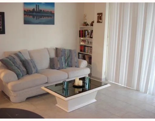 a living room with furniture a rug and a window