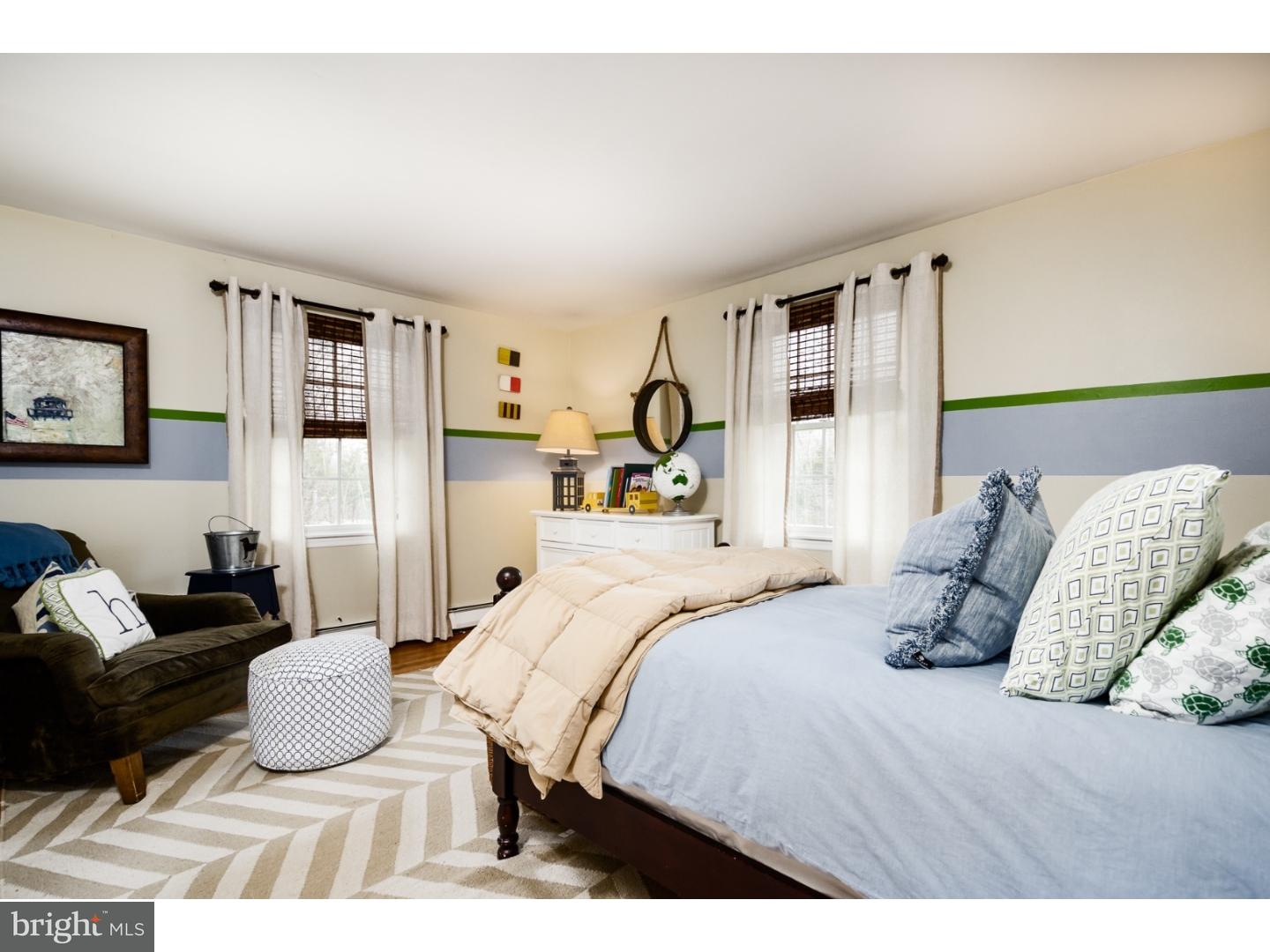 78 Bayberry Road Princeton, NJ 08540 - Photo 14 of 25 a bedroom with a bed a couch and a large mirror