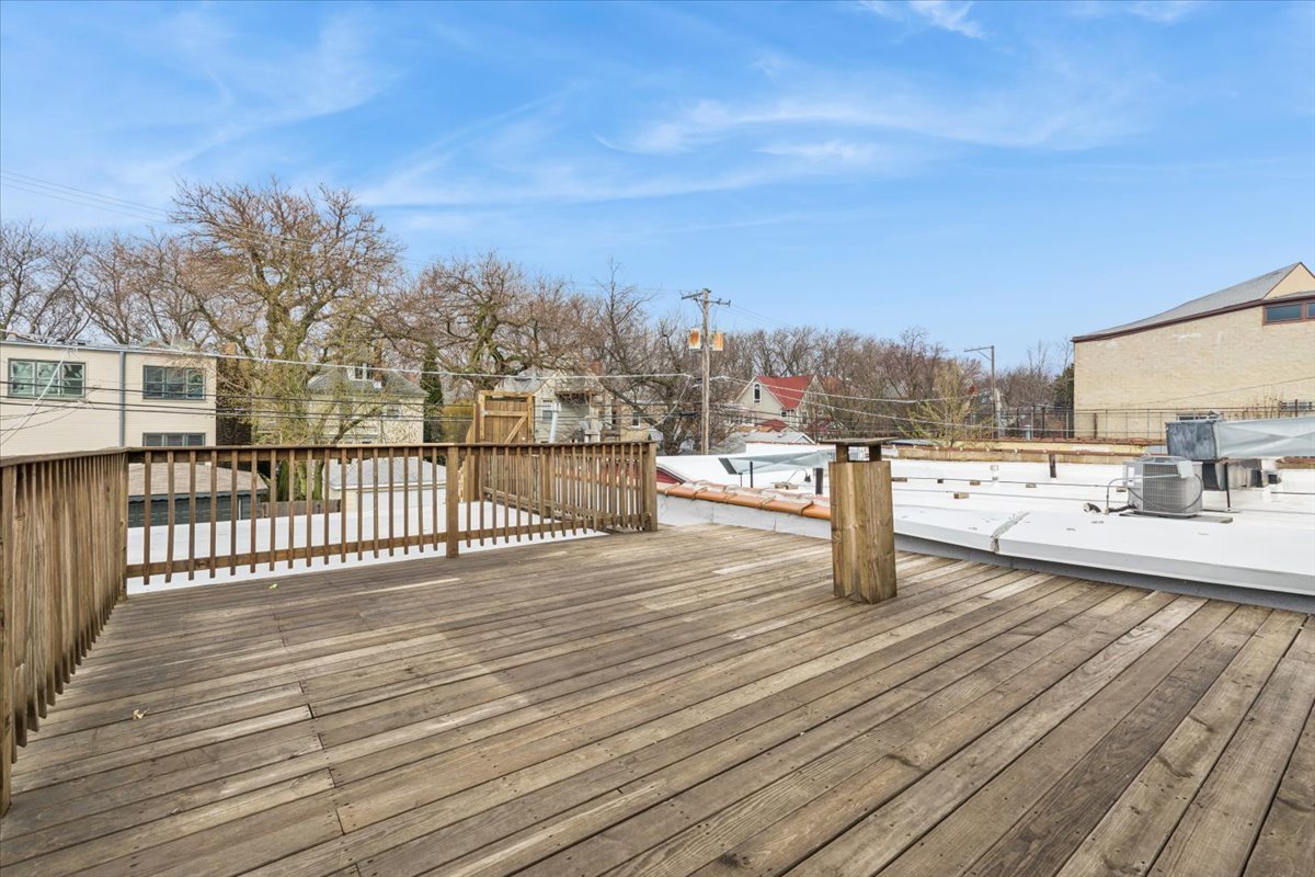 5414 North Broadway, Unit 2 Chicago, IL 60640 - Photo 18 of 18 a view of a terrace with wooden floor and fence