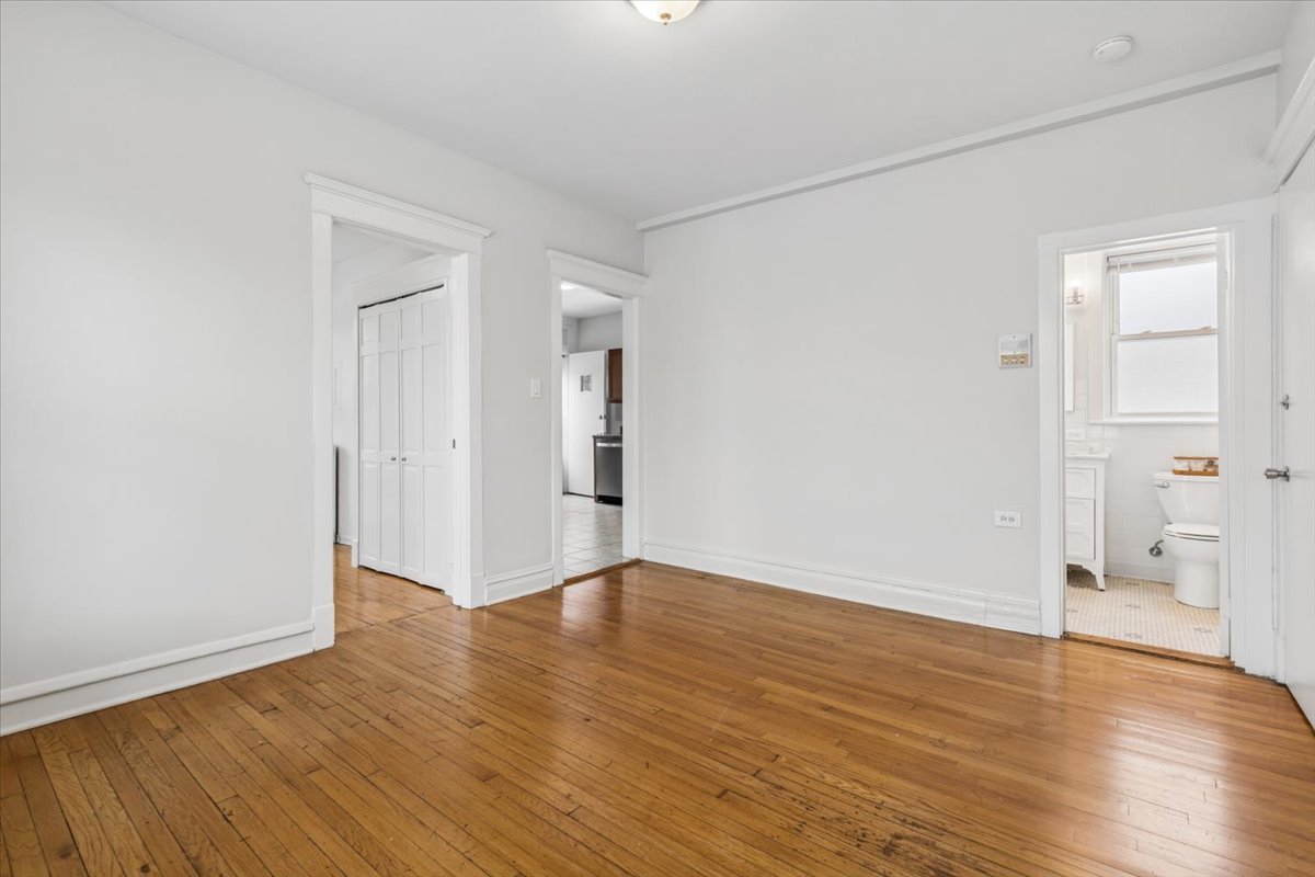 5414 North Broadway, Unit 2 Chicago, IL 60640 - Photo 5 of 18 a view of an empty room with wooden floor