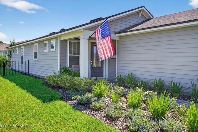 a open kitchen with stainless steel appliances granite countertop a stove top oven a sink dishwasher a dining table and chairs with wooden floor