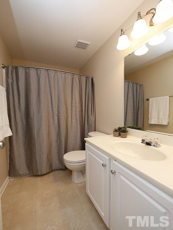 8341 City Loft Court Raleigh, NC 27613 - Photo 15 of 19 a bathroom with a sink a toilet and mirror