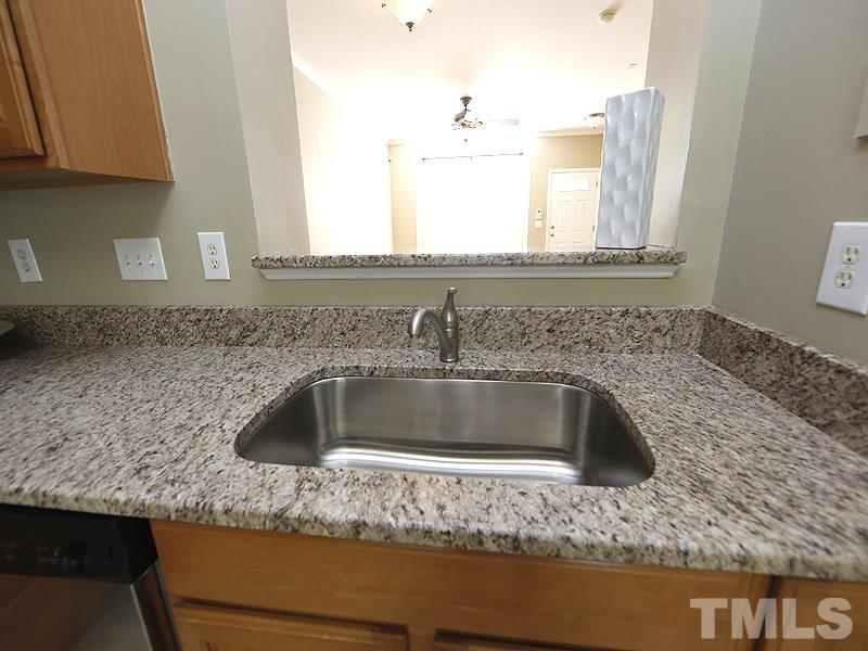 8341 City Loft Court Raleigh, NC 27613 - Photo 8 of 19 a kitchen with granite countertop a sink and a stove