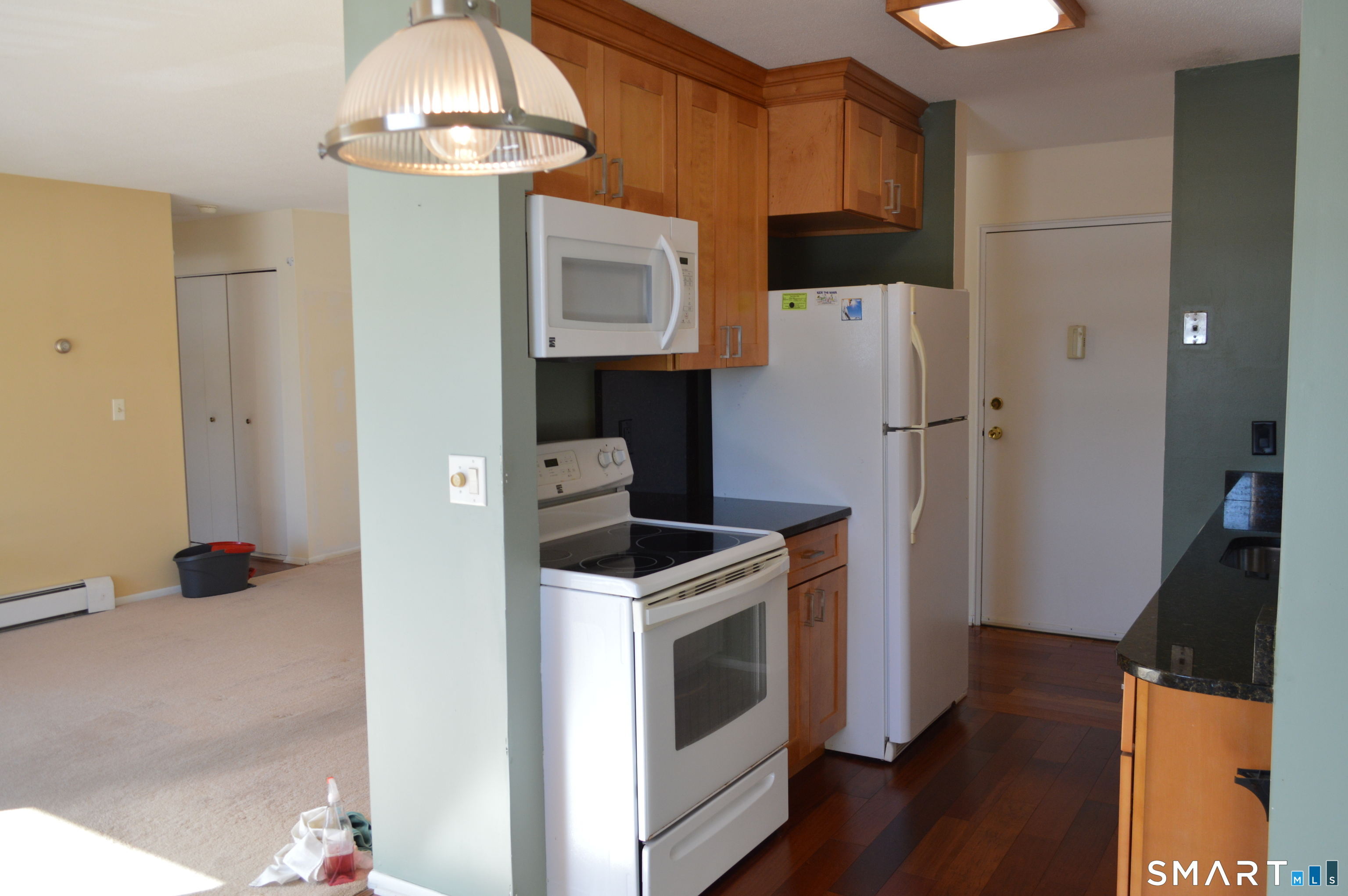 57 Balance Rock Road, Unit 17 Seymour, CT 06483 - Photo 7 of 18 a kitchen with a refrigerator a stove and wooden floor