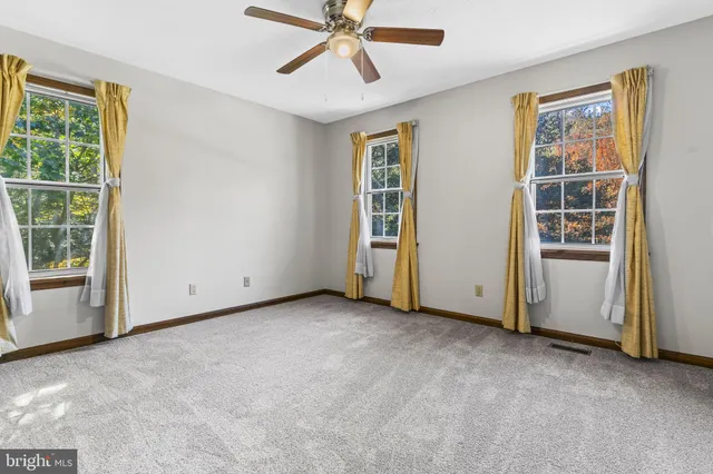 an empty room with windows and closet