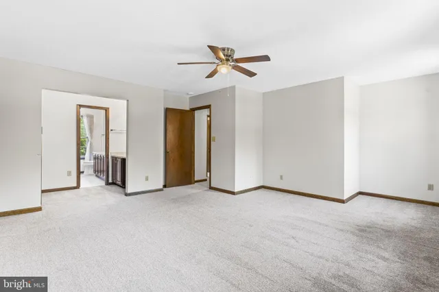 a view of empty room with ceiling fan