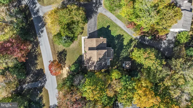 an aerial view of a house with a yard and garden