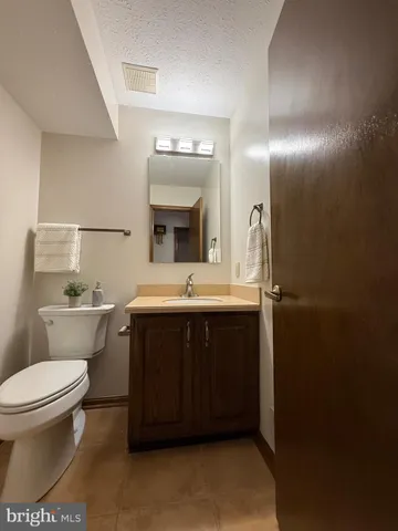 a bathroom with a sink toilet and mirror