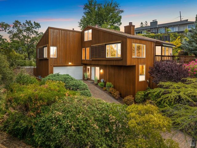 a view of a house with a small yard and plants