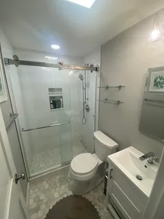 a bathroom with a toilet sink and a shower