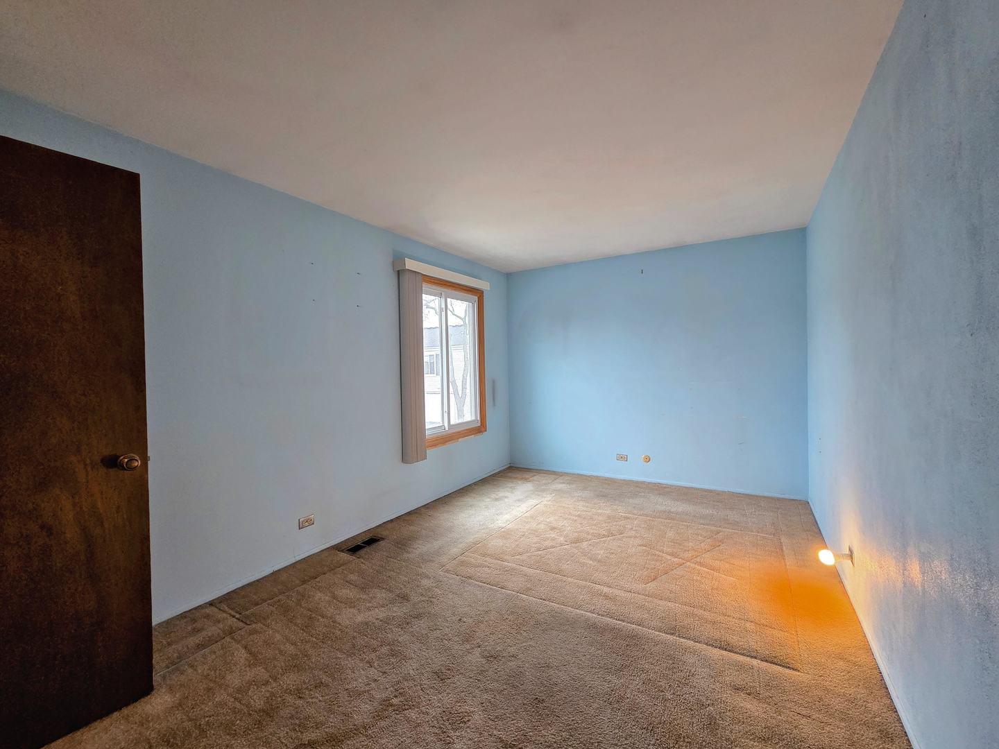 1481 Quaker Lane, Unit 117B Prospect Heights, IL 60070 - Photo 12 of 24 an empty room with windows