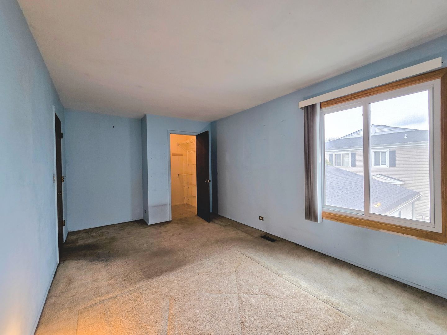 1481 Quaker Lane, Unit 117B Prospect Heights, IL 60070 - Photo 15 of 24 a view of an empty room with a window