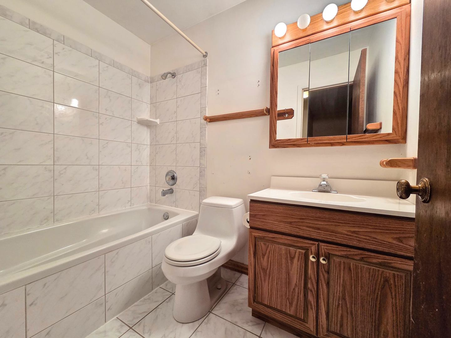 1481 Quaker Lane, Unit 117B Prospect Heights, IL 60070 - Photo 17 of 24 a bathroom with a sink a toilet and shower