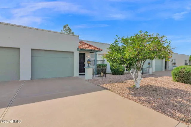 a view of a house with a yard and garage