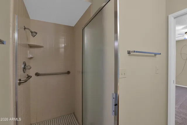 a bathroom with a glass shower door