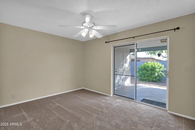 an empty room with windows and outdoor view