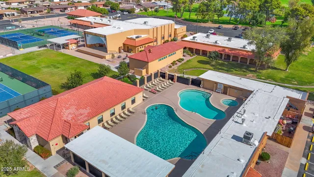 an aerial view of a house with a yard and lake view