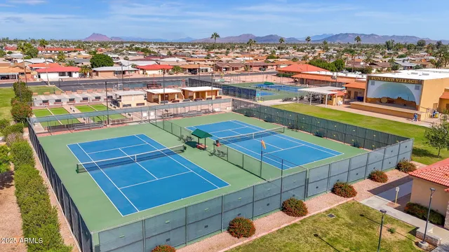 an aerial view of a balcony with chairs
