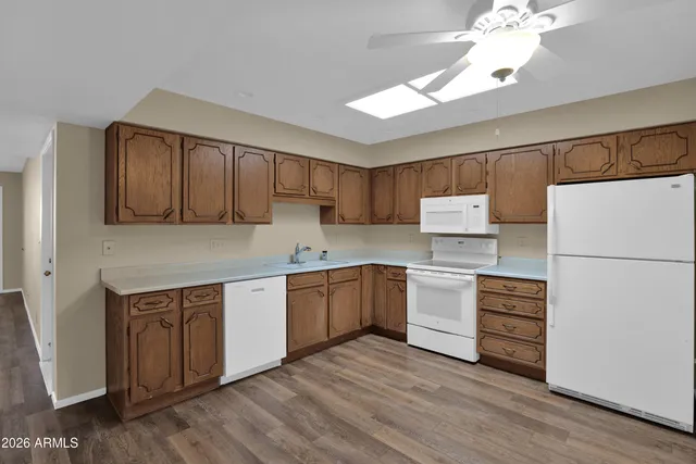 a kitchen with a refrigerator sink and cabinets
