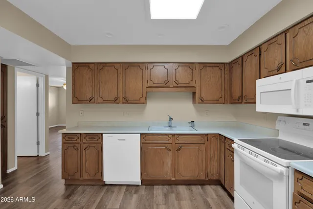 a kitchen with a sink a cabinets and wooden floor