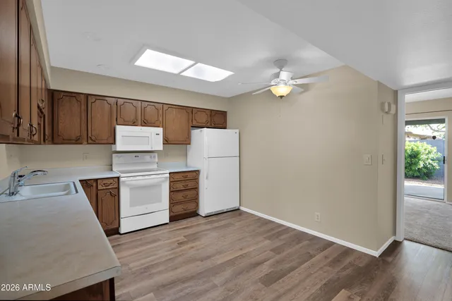 a kitchen with stove cabinets and wooden floor