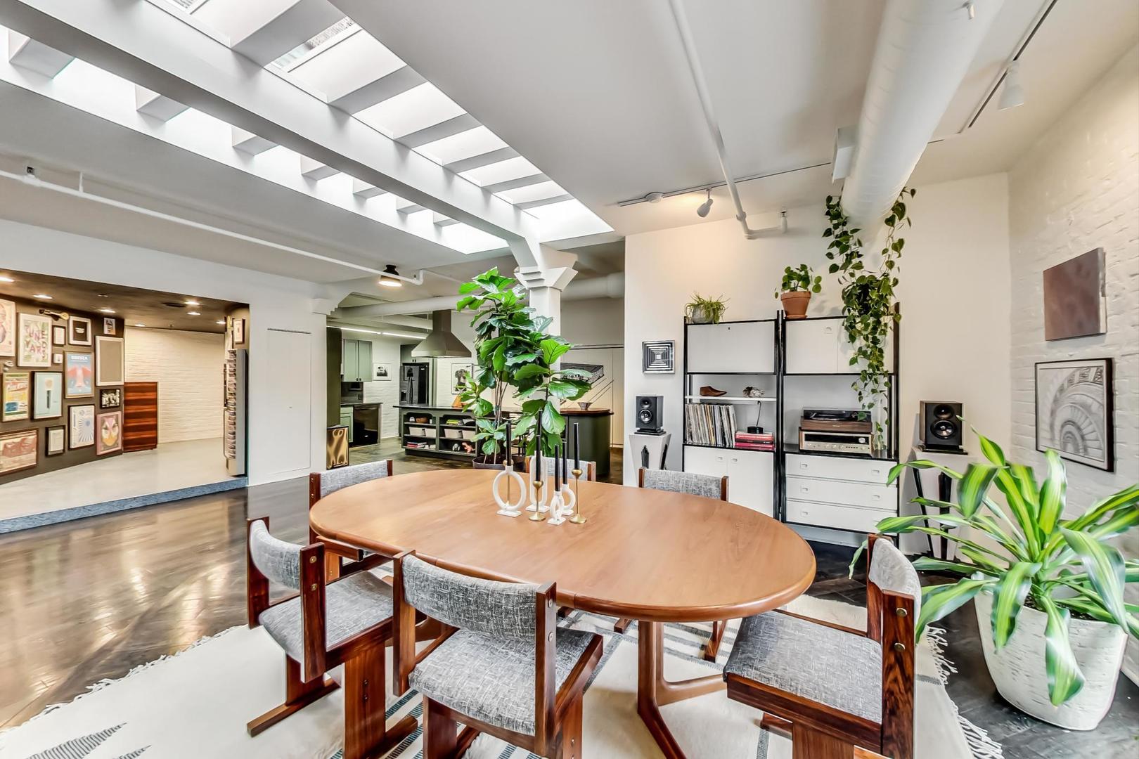 1147 West Ohio Street, Unit 201 Chicago, IL 60642 - Photo 21 of 54 a view of a dining room with furniture and wooden floor