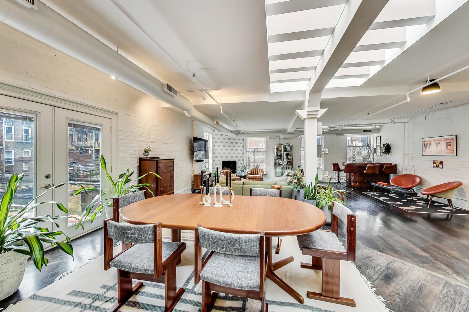 1147 West Ohio Street, Unit 201 Chicago, IL 60642 - Photo 22 of 54 a view of a dining room with furniture and wooden floor