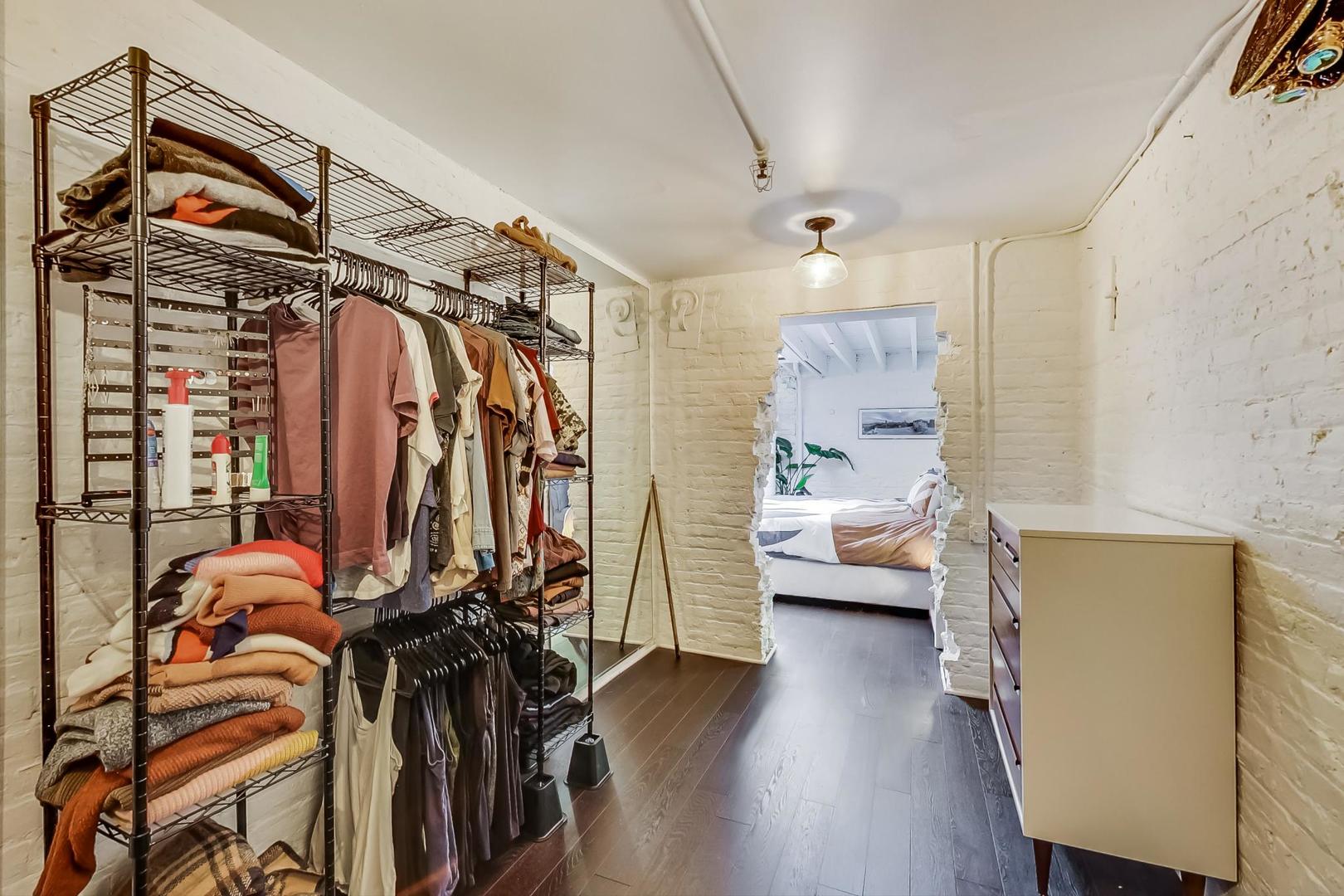 1147 West Ohio Street, Unit 201 Chicago, IL 60642 - Photo 41 of 54 a view of walk in closet with clothes and shoes