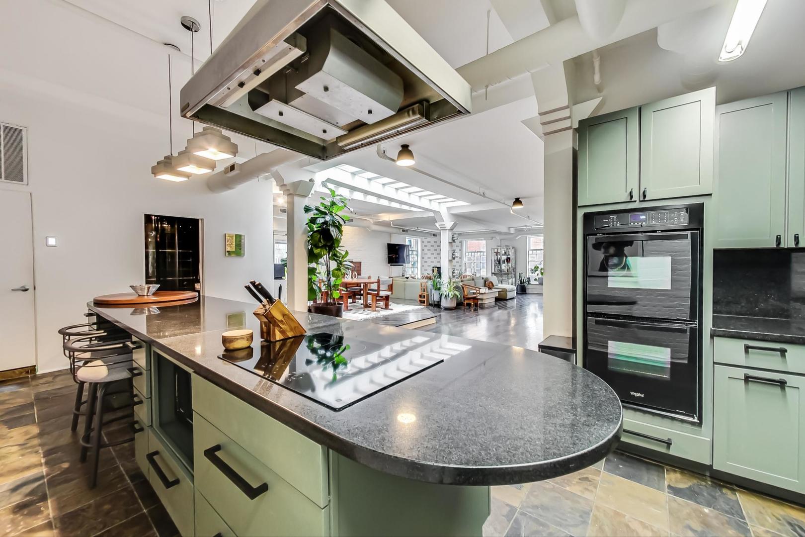 1147 West Ohio Street, Unit 201 Chicago, IL 60642 - Photo 6 of 54 a kitchen with stainless steel appliances granite countertop a sink a stove and a refrigerator