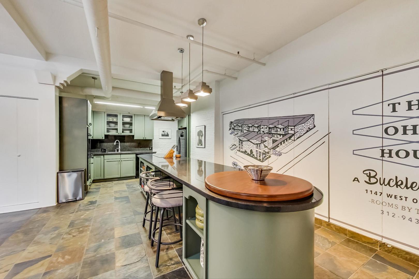 1147 West Ohio Street, Unit 201 Chicago, IL 60642 - Photo 7 of 54 a kitchen with stainless steel appliances kitchen island a table and chairs