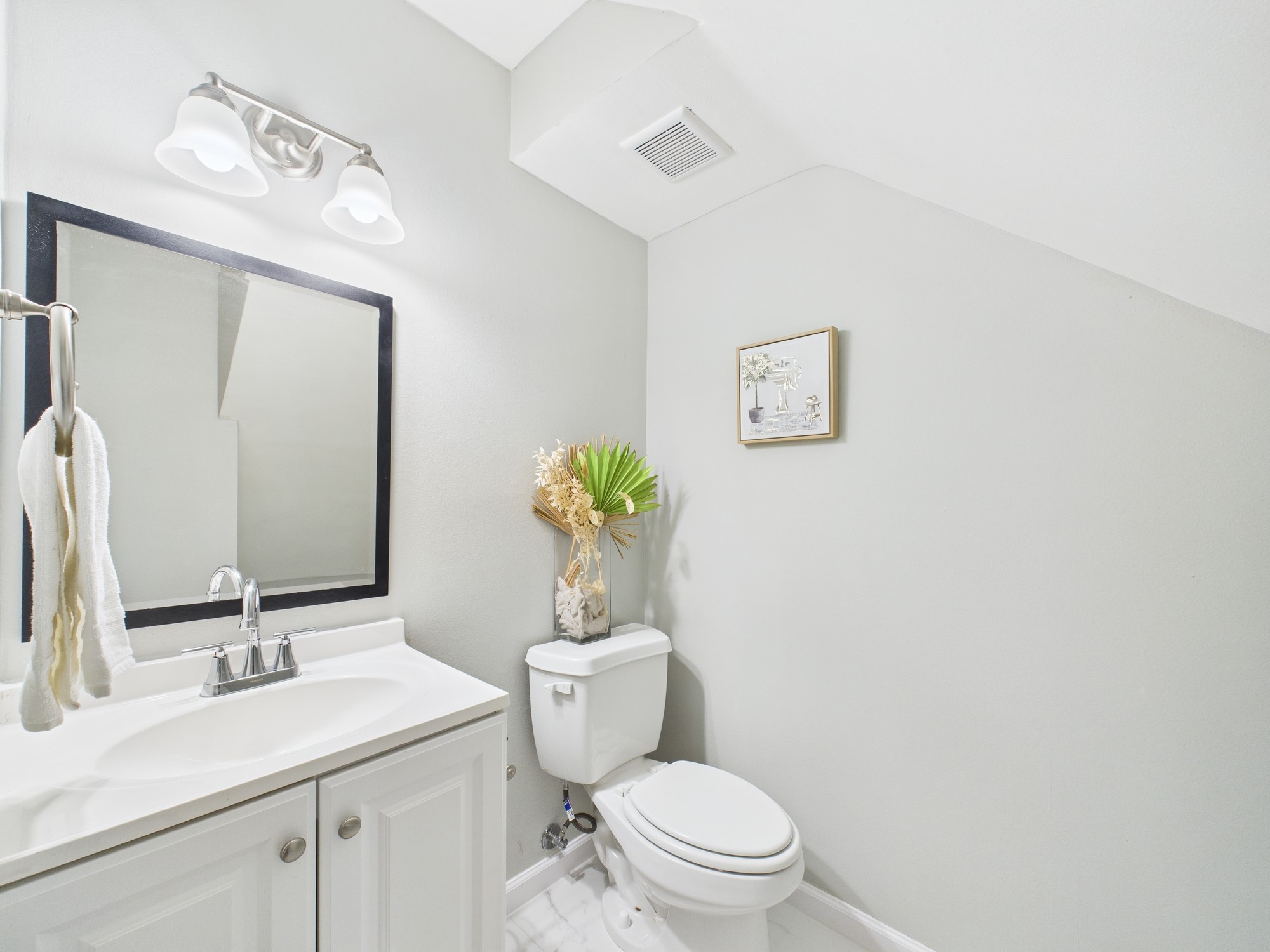 7836 Bateman Lane, Unit 7836 Houston, TX 77088 - Photo 10 of 44 a bathroom with a toilet a sink and mirror