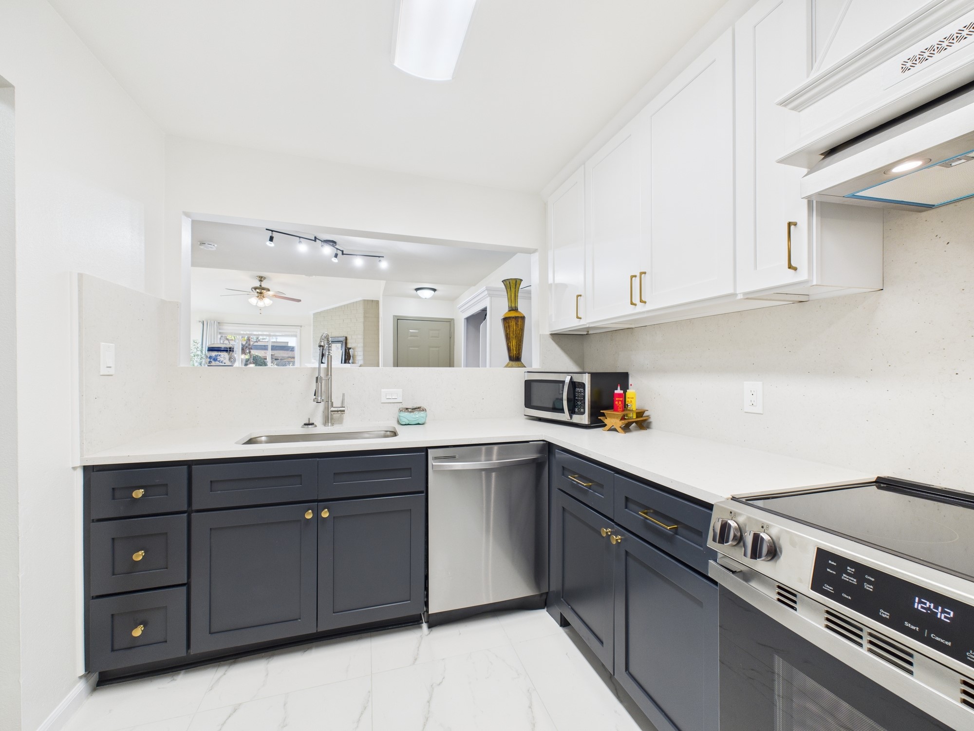 7836 Bateman Lane, Unit 7836 Houston, TX 77088 - Photo 12 of 44 a kitchen with a sink dishwasher and cabinets