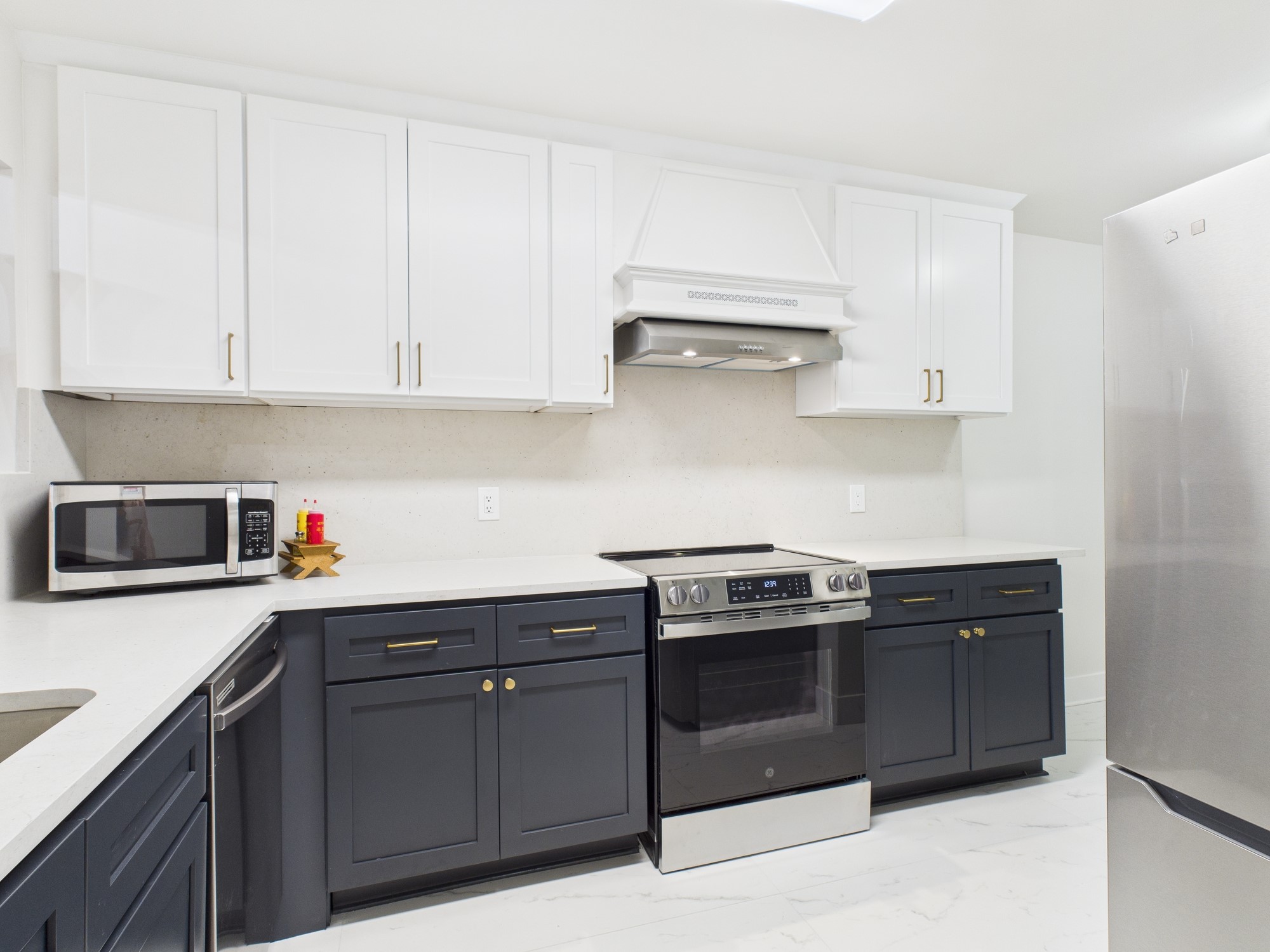 7836 Bateman Lane, Unit 7836 Houston, TX 77088 - Photo 13 of 44 a kitchen with stainless steel appliances granite countertop a stove a sink and a refrigerator