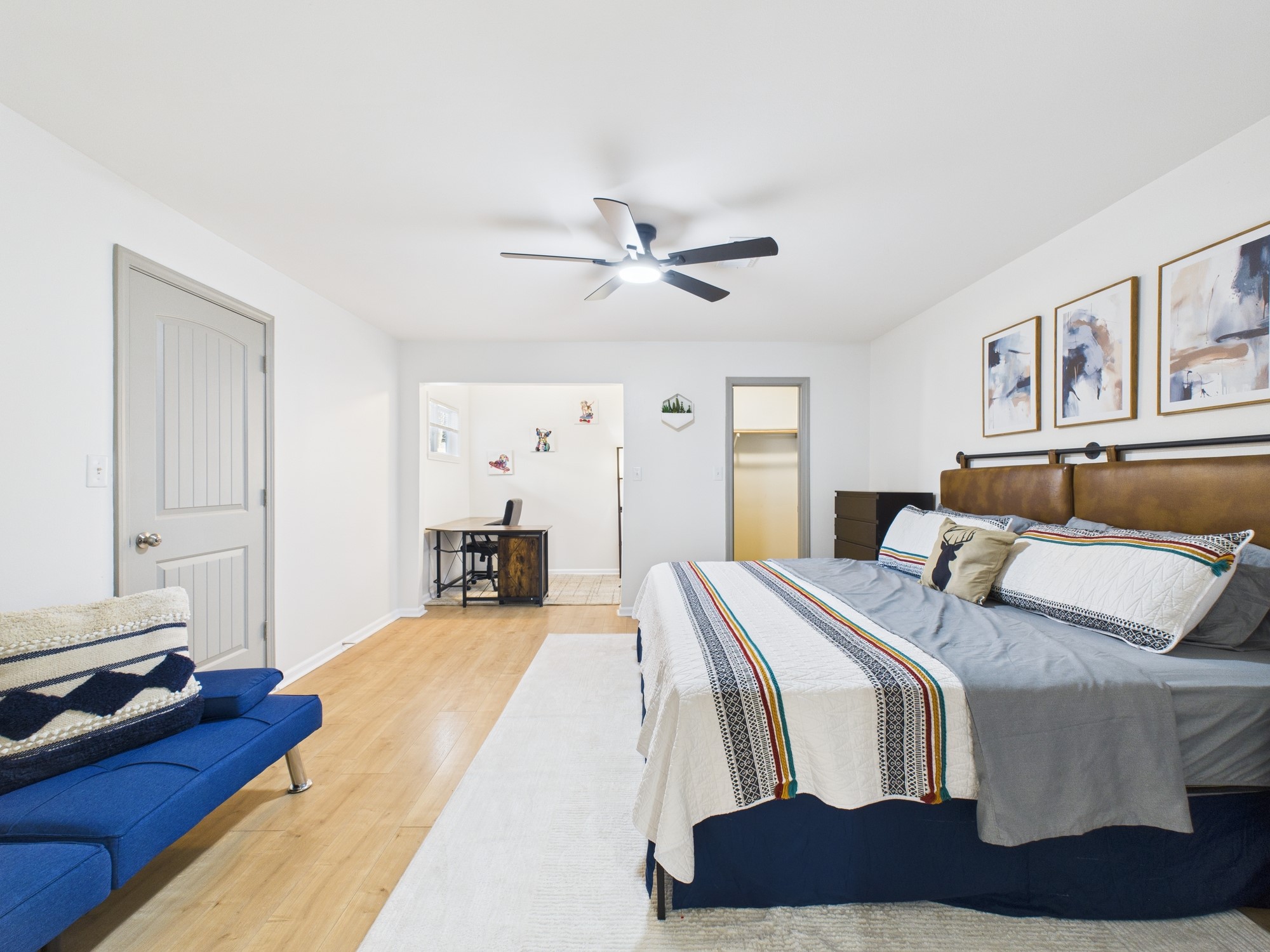 7836 Bateman Lane, Unit 7836 Houston, TX 77088 - Photo 22 of 44 a bed room with a bed and a chandelier