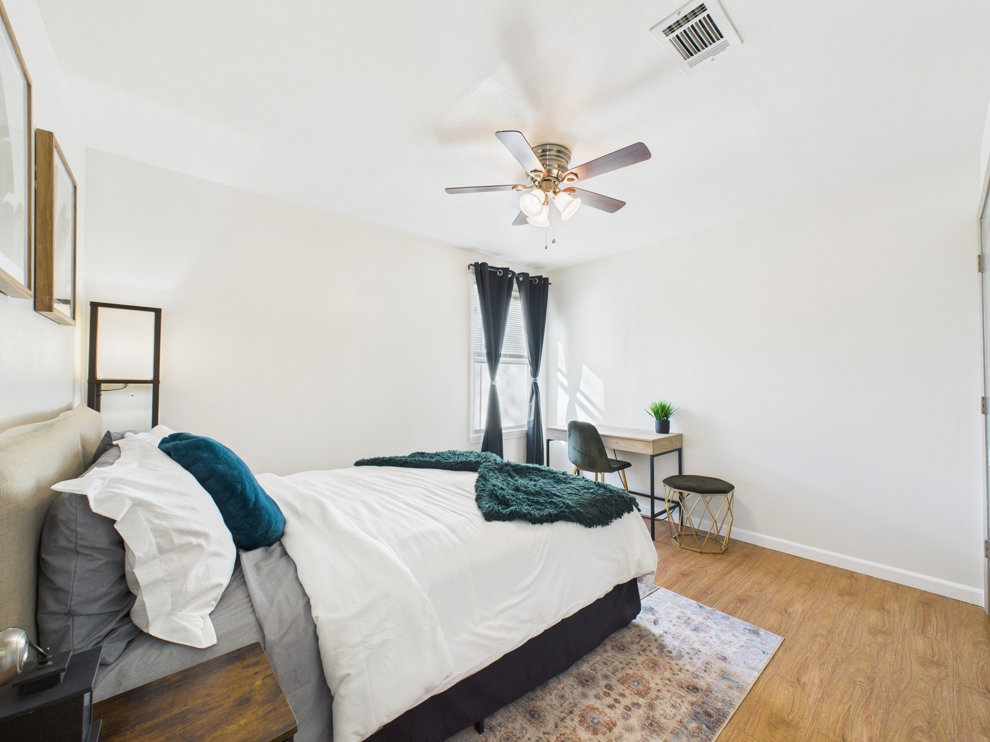 7836 Bateman Lane, Unit 7836 Houston, TX 77088 - Photo 28 of 44 a bedroom with a bed a table and chair