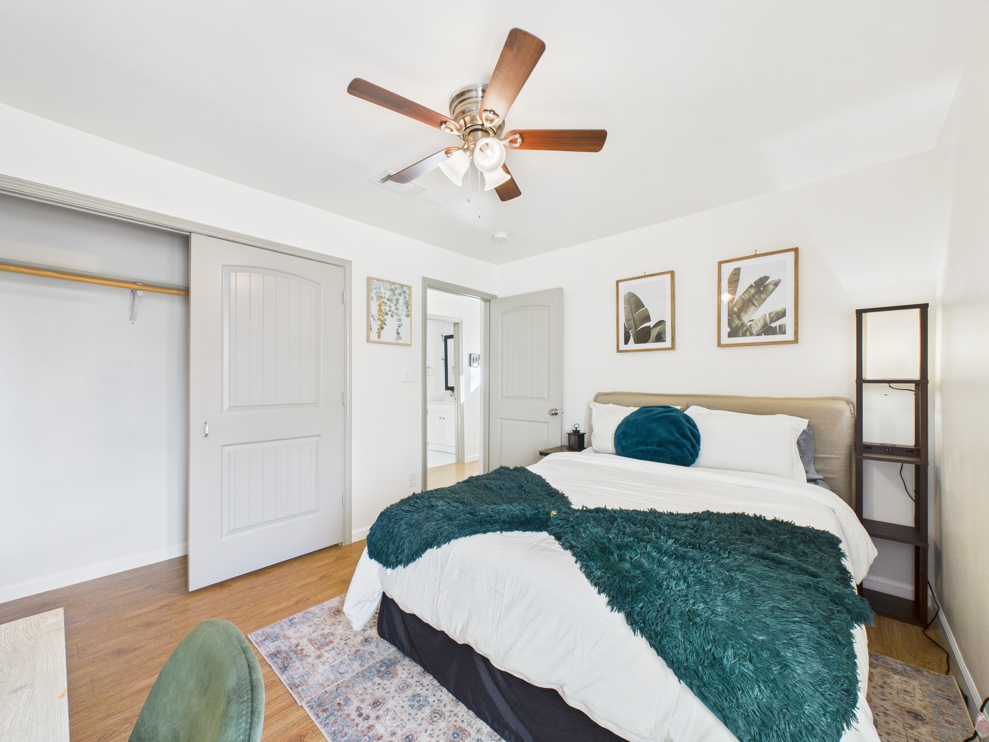 7836 Bateman Lane, Unit 7836 Houston, TX 77088 - Photo 29 of 44 a bedroom with a large bed and a chandelier