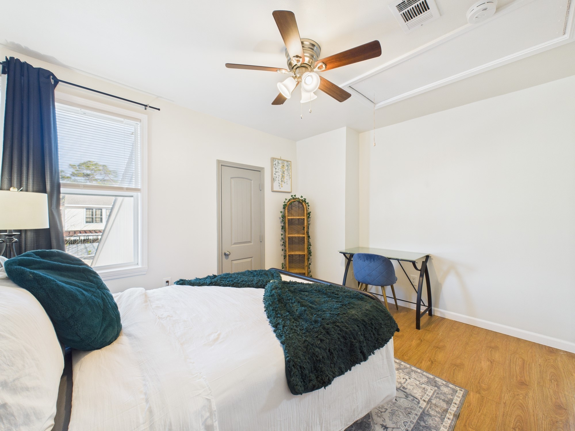 7836 Bateman Lane, Unit 7836 Houston, TX 77088 - Photo 34 of 44 a bedroom with a bed and a chandelier