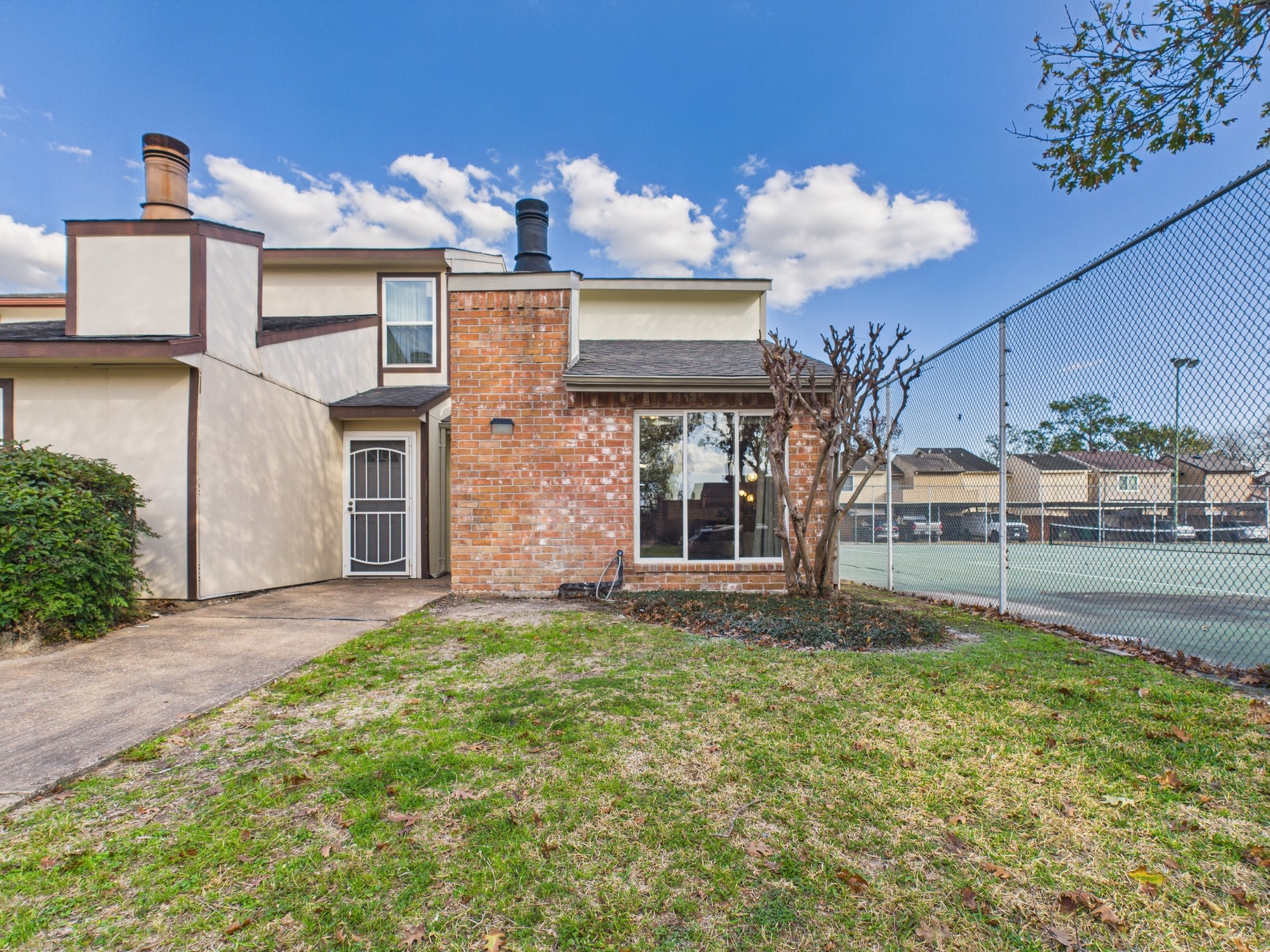 7836 Bateman Lane, Unit 7836 Houston, TX 77088 - Photo 40 of 44 a front view of a house with a yard and garage