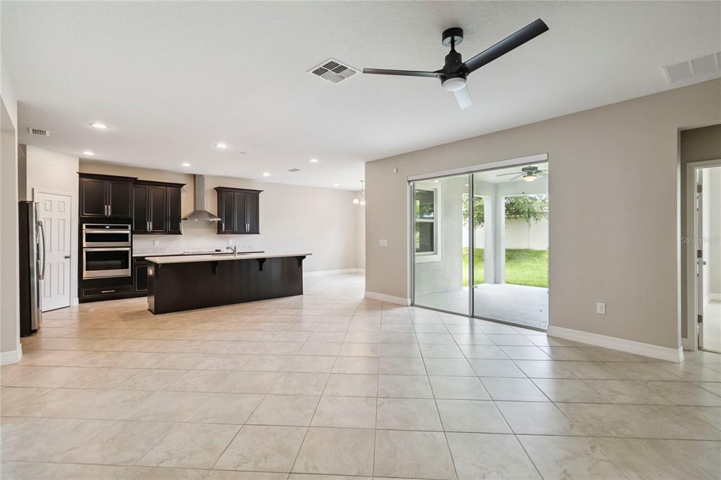 2066 Cresswell Street Ocoee, FL 34761 - Photo 11 of 32 a large kitchen with stainless steel appliances a sink a counter top space cabinets and a view of kitchen